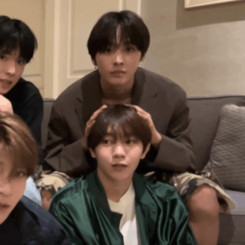Young Men Sitting On Couch One Holding Head GIF