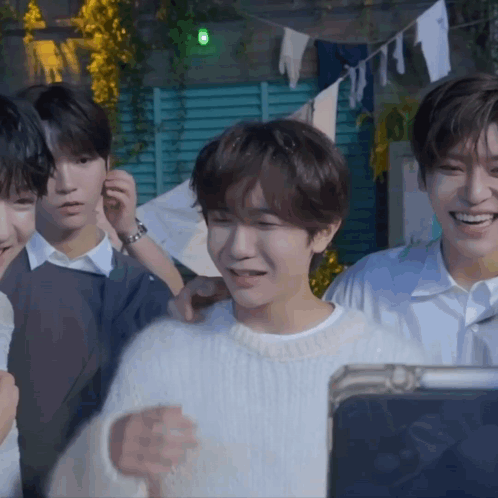 Young Men Smiling at Tablet