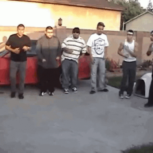 Young Men Standing In Front Of Red Car GIF