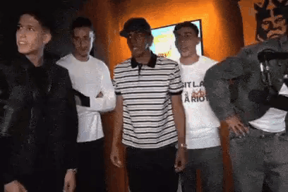 Young Men Standing in Front of Television