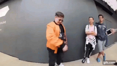 Young Men Standing In Front Of Wall GIF