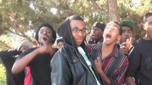 Young Men Standing In Line With Glasses And Hooded Jacket GIF