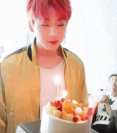 Young Red-Haired Man Holding Cake With Candle