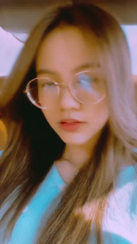 Young Woman In Glasses And Blue Shirt GIF