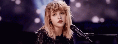 Young Woman Singing Into Microphone