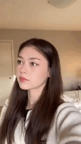 Young Woman Taking Selfie in Bedroom