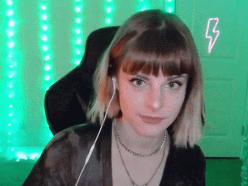 Young Woman With Headphones In Front Of Green Lightning Bolt GIF