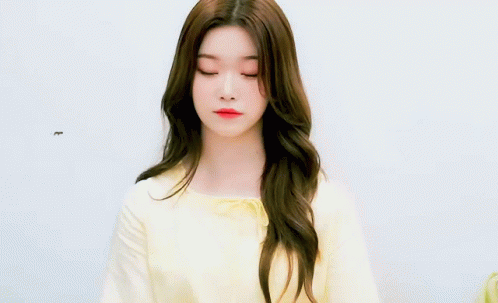 Young Woman With Long Brown Hair In Yellow Shirt GIF