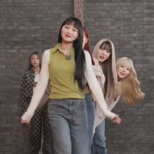 Young Women Dancing In Front Of Brick Wall GIF