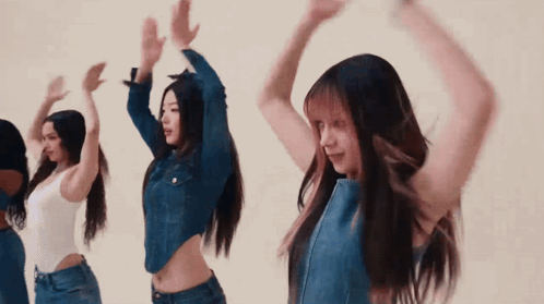 Young Women Dancing With Hands In Air GIF