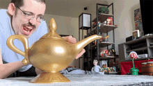 Youtuber Ricky Berwick Rubbing Golden Genie Lamp GIF