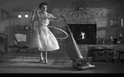 80S Lady Cleaning While Doing Holla Hoop GIF