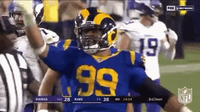 99 Football Player Celebrating Touchdown In Blue And Yellow Uniform GIF