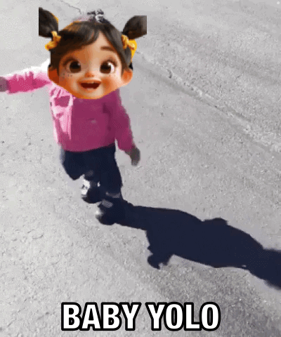 A Baby Doll Is Running Down A Street With The Words Baby Yolo Behind Her GIF
