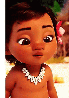 A Baby Doll Wearing A Necklace With Shells And A Flower In Her Hair . GIF