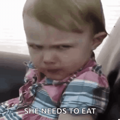 A Baby Girl Is Crying While Sitting In A Car Seat And Says `` She Needs To Eat '' . GIF