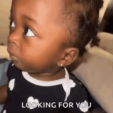 A Baby Girl Is Looking At The Camera With The Words `` Looking For You '' Written On The Bottom . GIF