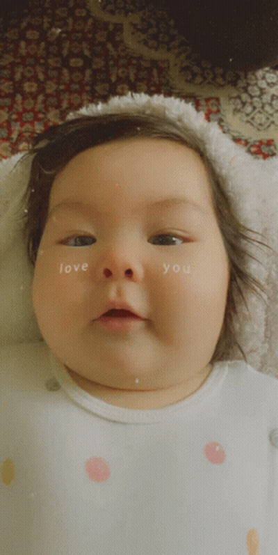 A Baby Has The Words Love You Written On Her Face GIF