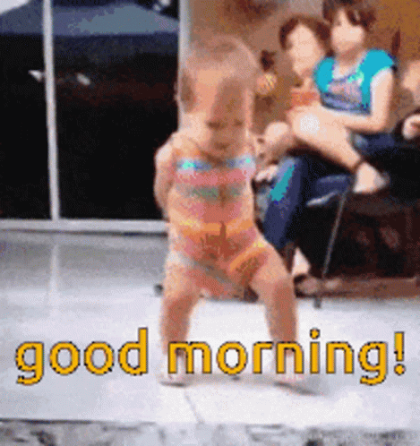 A Baby In A Bathing Suit Is Dancing In Front Of A Sign That Says " Good Morning " GIF