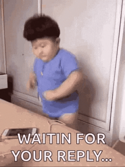 A Baby In A Blue Shirt Is Waiting For A Reply From Someone . GIF