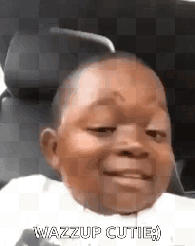 A Baby In A Car Seat With The Words Wazzup Cutie On The Bottom GIF