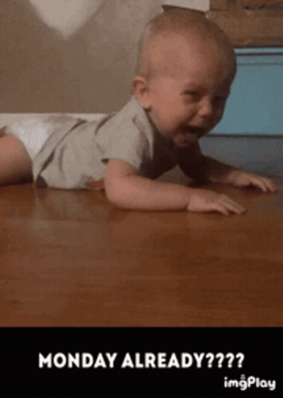 A Baby In A Diaper Is Crawling On A Wooden Floor With The Caption Monday Already GIF