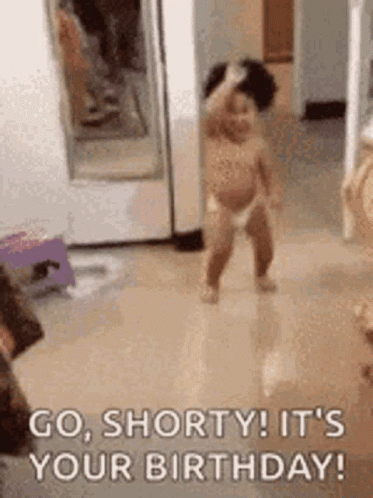 A Baby In A Diaper Is Standing On The Floor In A Room . GIF