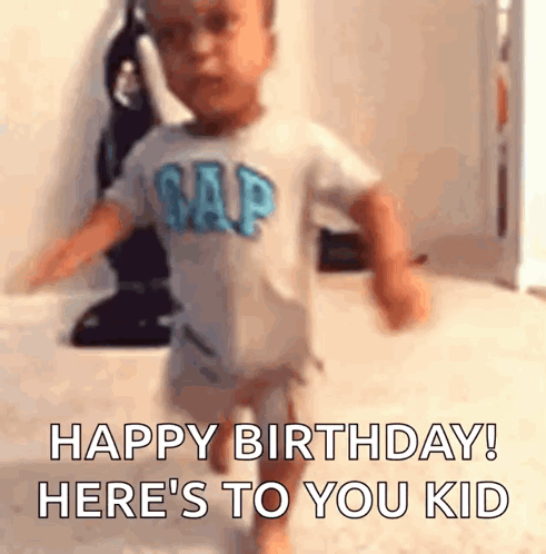 A Baby In A Gap Shirt Is Running In A Room And Saying `` Happy Birthday ! Here 'S To You Kid '' . GIF