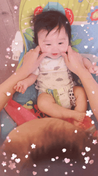 A Baby In A High Chair Being Held By A Person GIF