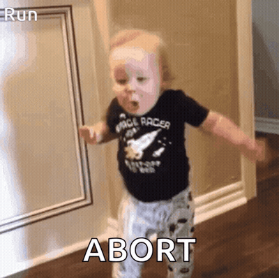 A Baby In A Space Racer Shirt Is Dancing In A Hallway With The Word Abort In The Corner . GIF