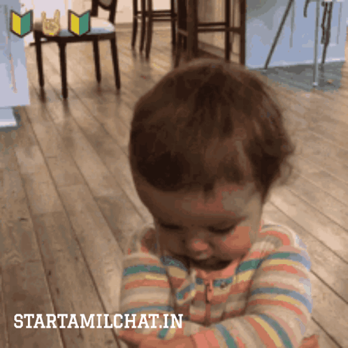 A Baby In A Striped Shirt Is Looking Down With The Words Starttamilchat.in Below It GIF
