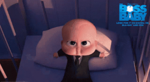 A Baby In A Suit And Tie Is Crying In Front Of A Poster That Says Boss Baby GIF