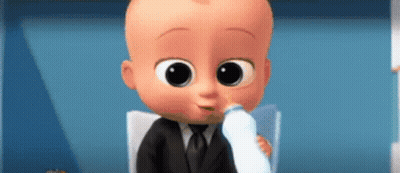 A Baby In A Suit Is Drinking Milk From A Bottle . GIF