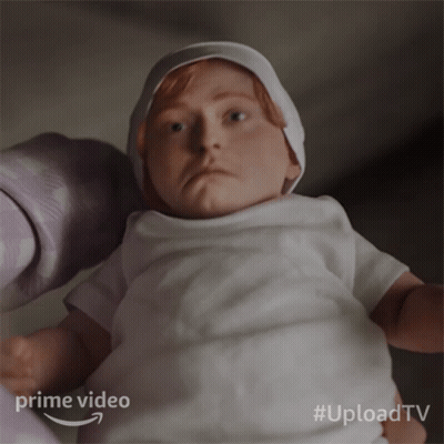 A Baby In A White Shirt Is Being Held By A Person With The Words Prime Video Behind It GIF