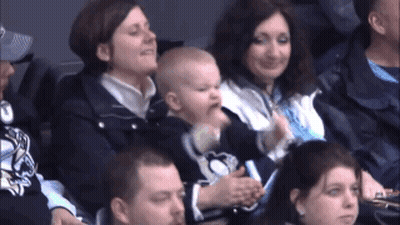 A Baby Is Being Held By A Woman In A Pittsburgh Penguins Shirt GIF