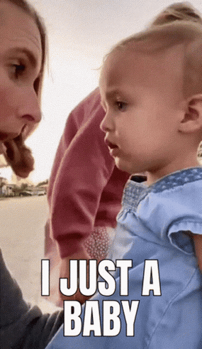 A Baby Is Being Held By A Woman With A Caption That Says I Just A Baby GIF