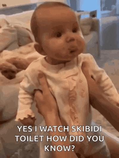 A Baby Is Being Held In A Person 'S Arms And Making A Funny Face . GIF