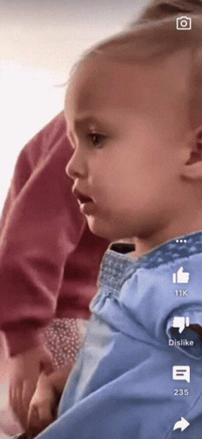 A Baby Is Being Held In Someone 'S Arms With The Number 235 On The Bottom GIF