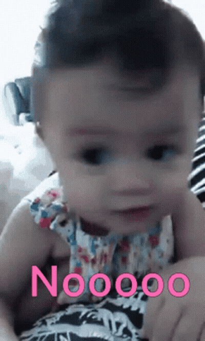 A Baby Is Being Held In Someone 'S Arms With The Word Noooo On The Bottom Right GIF