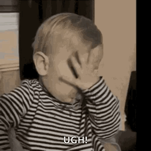 A Baby Is Covering His Face With His Hand And Saying Ugh . GIF