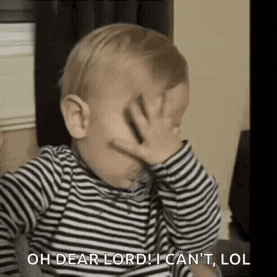 A Baby Is Covering His Face With His Hand . GIF