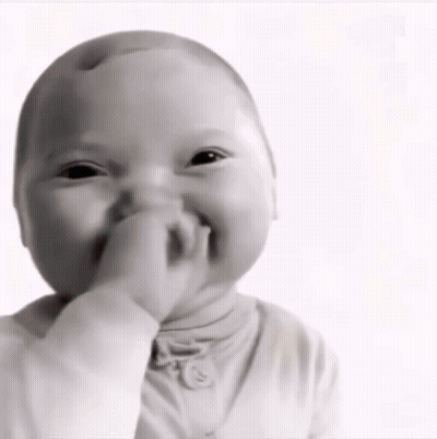 A Baby Is Covering His Mouth With His Hand GIF