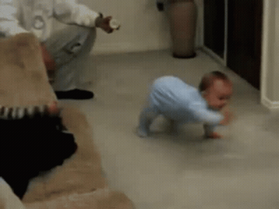 A Baby Is Crawling On The Floor In A Living Room While A Man Holds A Bottle . GIF