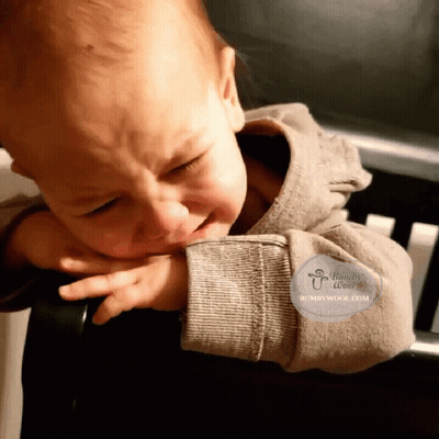A Baby Is Crying And Has A Humbywool.com Logo On His Arm GIF