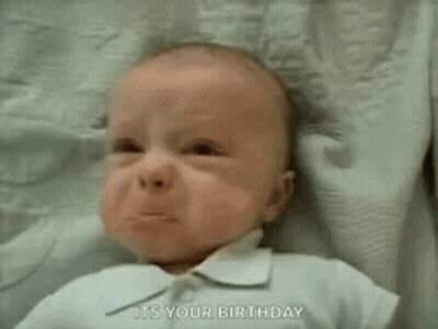 A Baby Is Crying And Saying `` It 'S Your Birthday '' While Laying On A Blanket . GIF