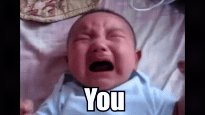 A Baby Is Crying While Laying On A Bed And The Baby Is Saying `` You '' . GIF