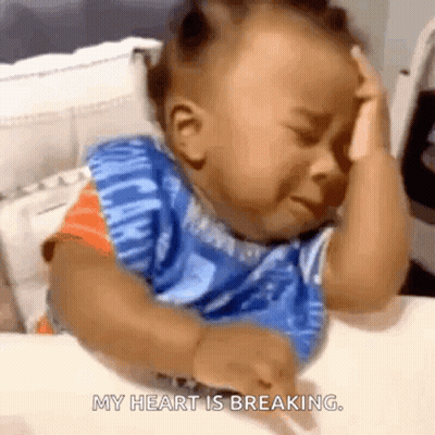 A Baby Is Crying While Sitting At A Table And The Words My Heart Is Breaking Are Visible GIF