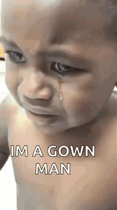 A Baby Is Crying With A Tear Coming Out Of His Eye And Says `` Im A Gown Man '' . GIF