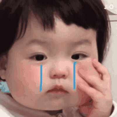 A Baby Is Crying With Tears Coming Out Of Her Eyes . GIF
