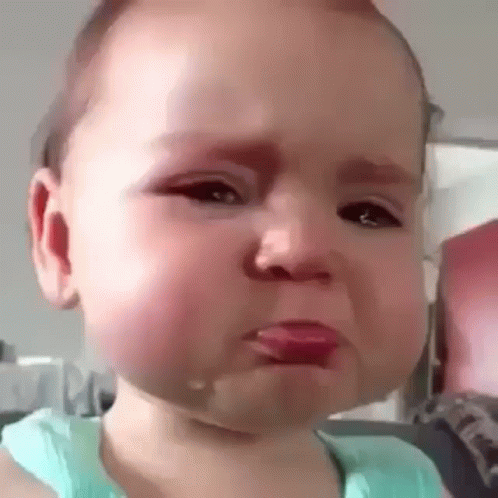 A Baby Is Crying With Tears Coming Out Of His Mouth . GIF